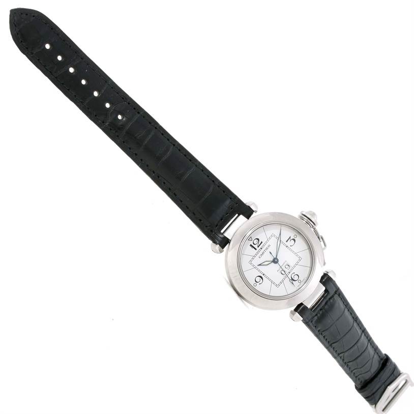 The image shows a top-down view of a Cartier Pasha W31055M7 Men's Stainless Steel Silver Dial W31055M7 Men's Stainless Steel Silver Dial watch, displaying the face and black leather strap.