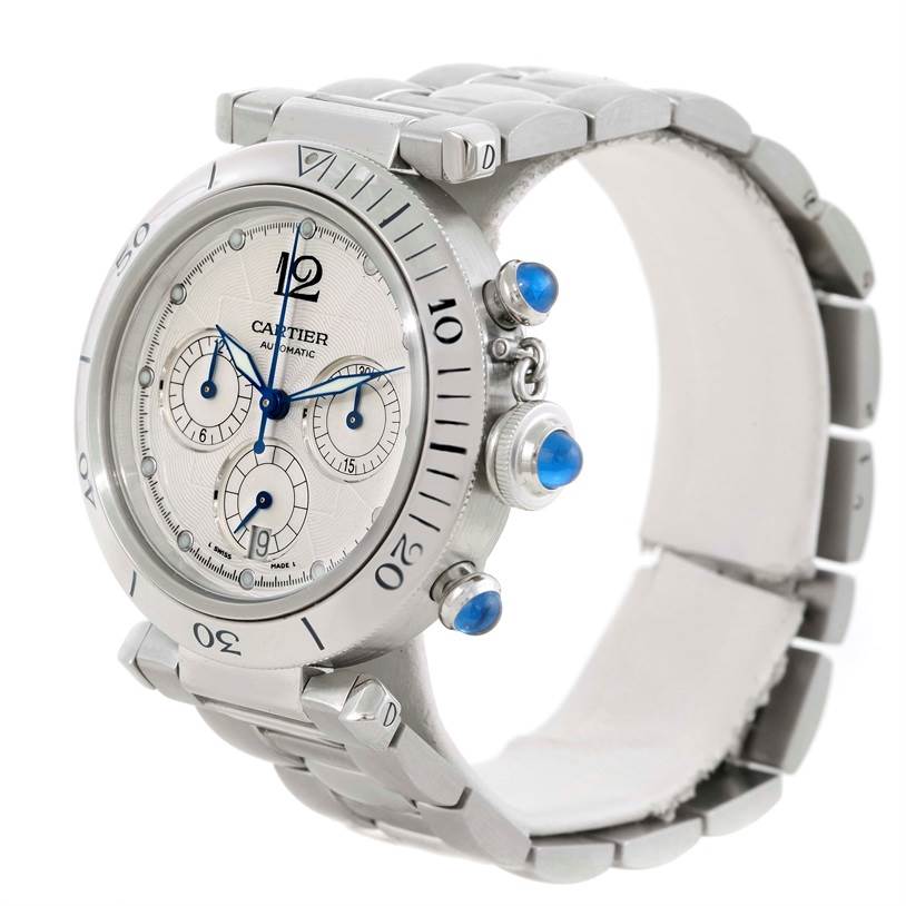 The image shows a side-angle view of a Cartier Pasha W31030H3 Men
s Stainless Steel Silver Dial W31030H3 Men
s Stainless Steel Silver Dial watch, highlighting its face, bezel, and blue gemstone crown and pushers.