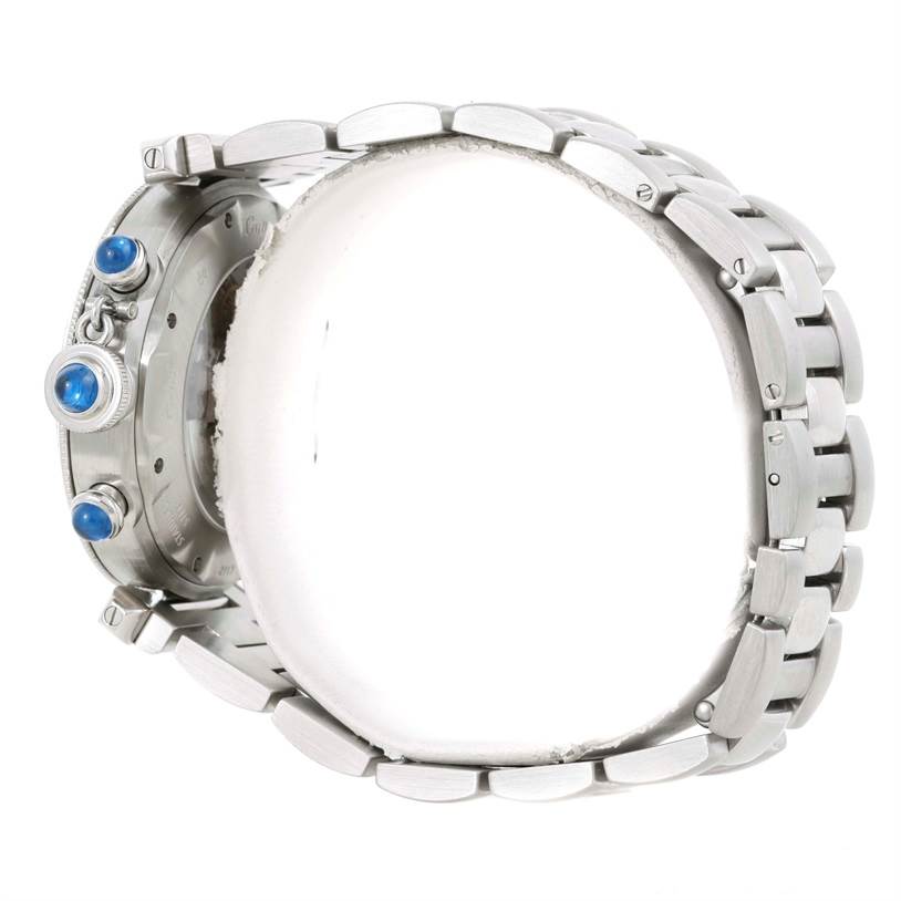 The image shows a side view of a Cartier Pasha W31030H3 Men
s Stainless Steel Silver Dial W31030H3 Men
s Stainless Steel Silver Dial watch, highlighting the crown and pushers with blue cabochons, along with the metal bracelet.