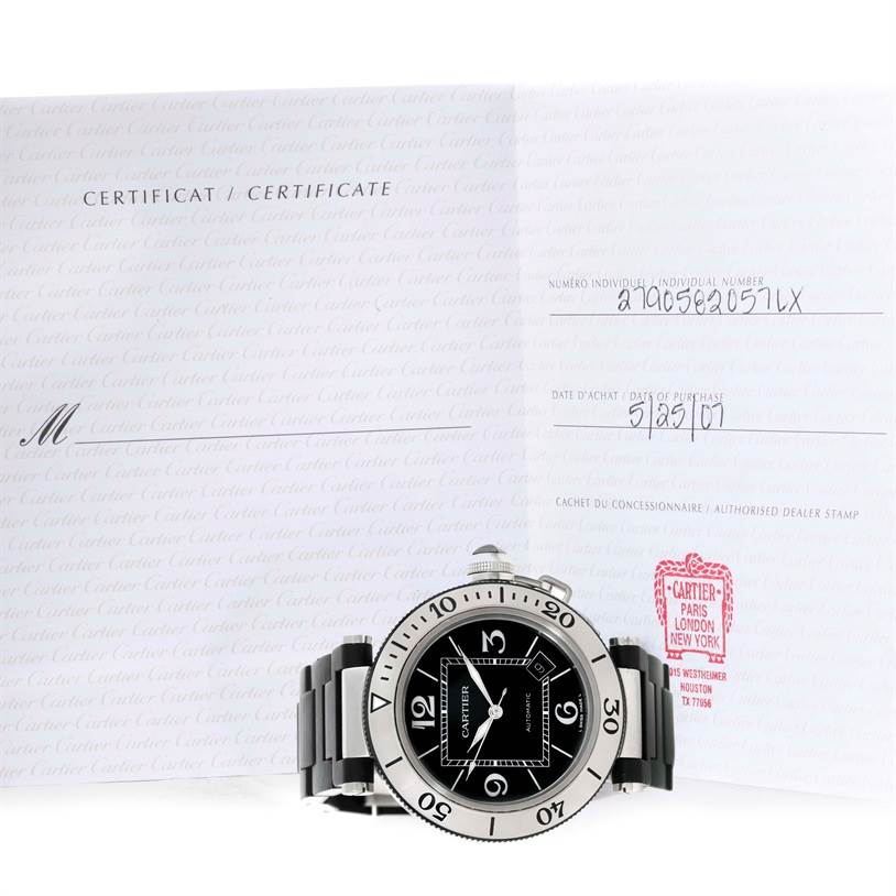 The image shows a Cartier Pasha W31077U2 Men's Stainless Steel Black Dial W31077U2 Men's Stainless Steel Black Dial watch from a front angle, displayed in front of its certificate of authenticity.