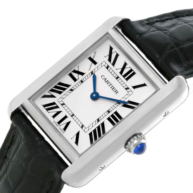 The Cartier Tank Solo W1018255 Women's Stainless Steel Silver Dial W1018255 Women's Stainless Steel Silver Dial watch is shown at an angled close-up, highlighting the dial, leather strap, and beaded crown with a blue cabochon.
