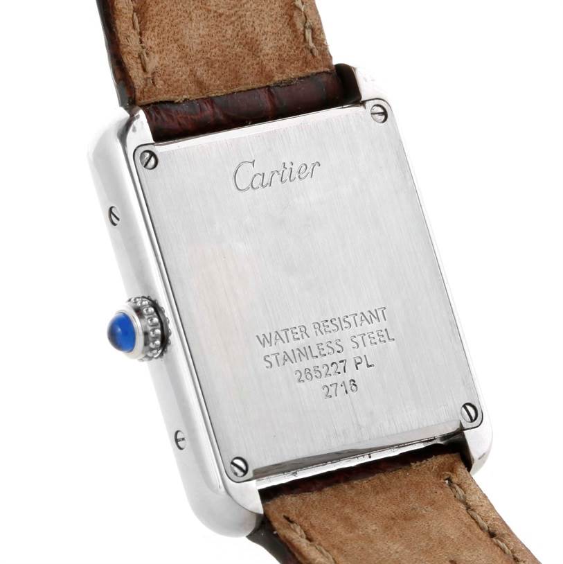 The image shows the back case and part of the leather strap of a Cartier Tank Solo W1018255 Women's Stainless Steel Silver Dial W1018255 Women's Stainless Steel Silver Dial watch, highlighting its stainless steel case and water resistance details.