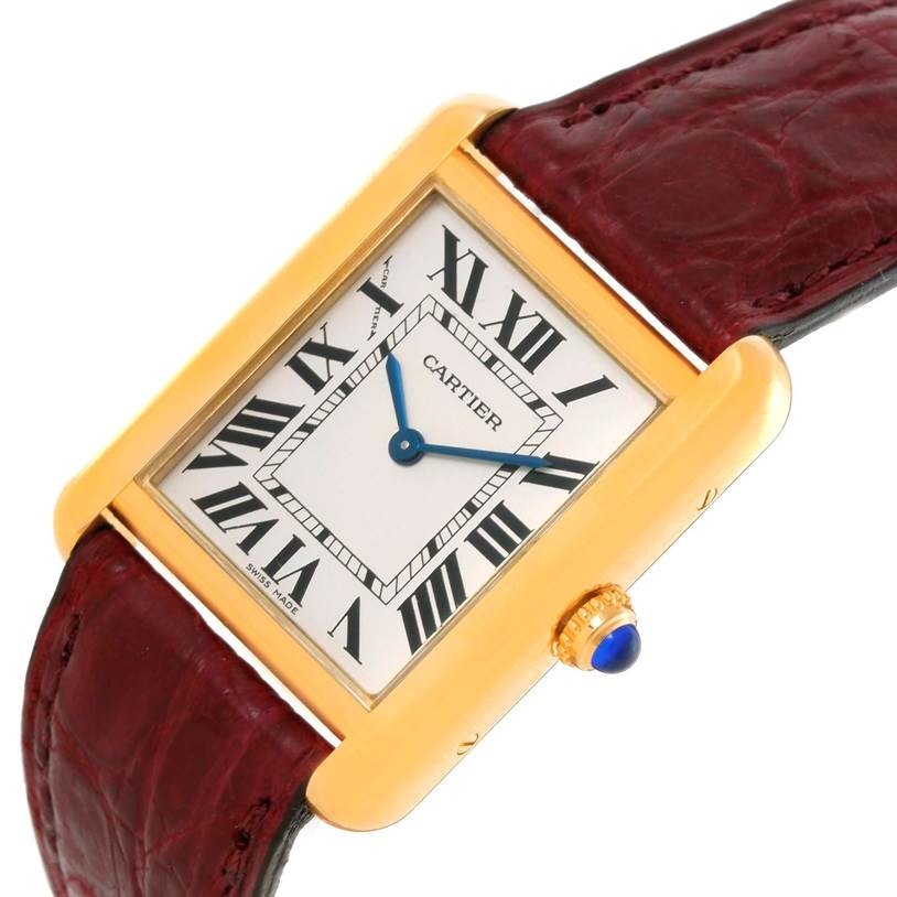 The image shows a Cartier Tank Solo W1018755 Women's Steel and Gold (two tone) Silver Dial W1018755 Women's Steel and Gold (two tone) Silver Dial watch at an angled view, highlighting its gold case, white dial with Roman numerals, and burgundy leather strap.