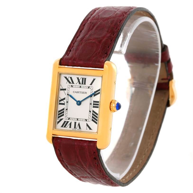 The Cartier Tank Solo W1018755 Women's Steel and Gold (two tone) Silver Dial W1018755 Women's Steel and Gold (two tone) Silver Dial watch is shown at a slight angle displaying its rectangular face, roman numerals, blue hands, and maroon leather strap.