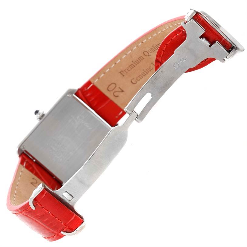The image shows the back case and clasp mechanism of a Cartier Tank Solo W1018355 Women's Stainless Steel Silver Dial W1018355 Women's Stainless Steel Silver Dial watch with a red leather strap.