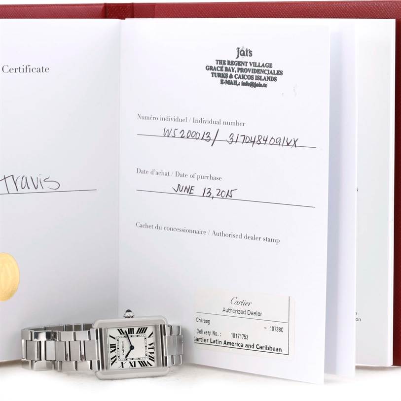 The image shows the Cartier Tank Solo W5200013 Women
s Stainless Steel Silver Dial W5200013 Women
s Stainless Steel Silver Dial watch lying flat next to its purchase certificate and documents.