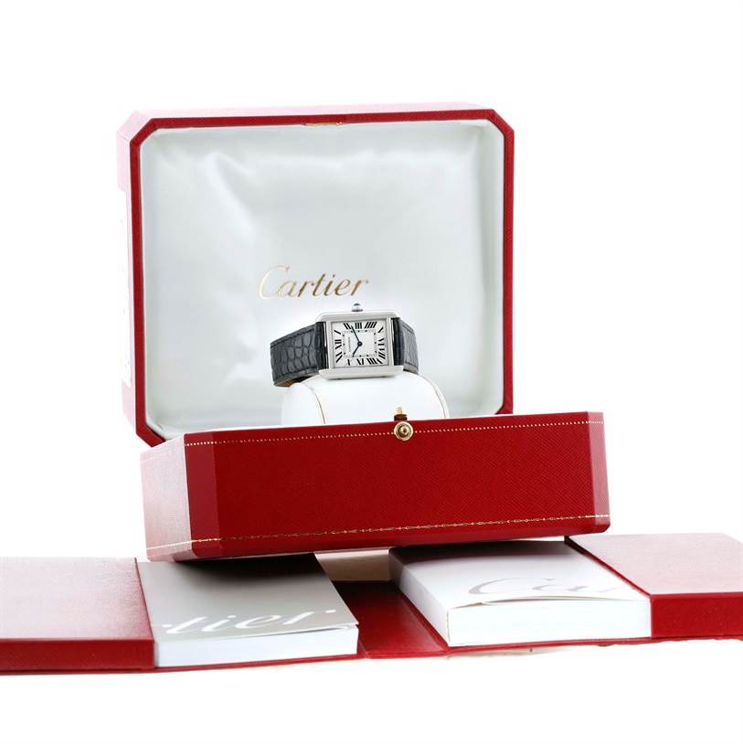 The Cartier Tank Solo W1018255 Women's Stainless Steel Silver Dial W1018255 Women's Stainless Steel Silver Dial watch is displayed frontally in its open presentation box, along with branded booklets and packaging.