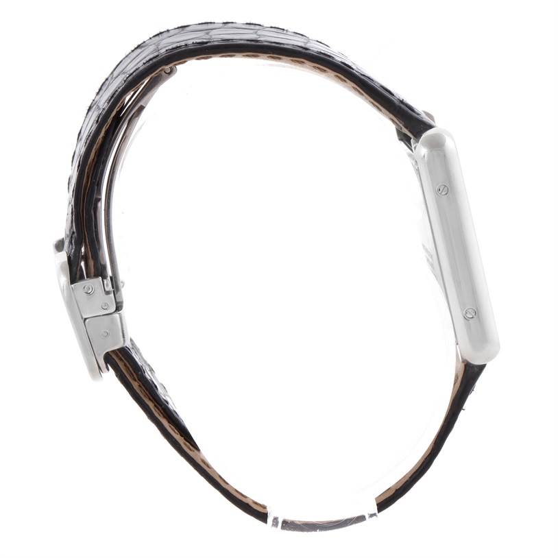 The Cartier Tank Solo W1018255 Women
s Stainless Steel Silver Dial W1018255 Women
s Stainless Steel Silver Dial watch is shown from a side view, highlighting the case, strap, and side screws.