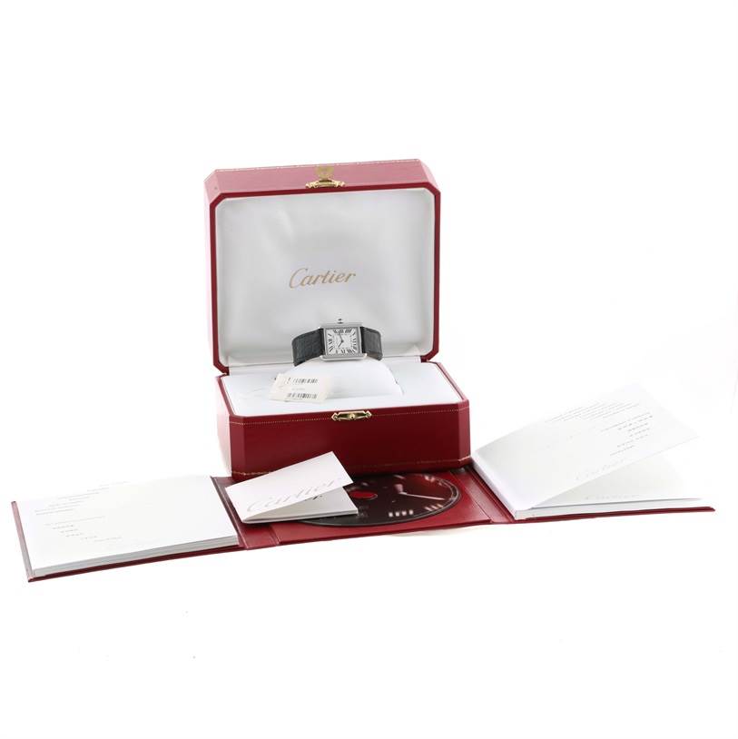 The image shows a Cartier Tank Solo W1018255 Women
s Stainless Steel Silver Dial W1018255 Women
s Stainless Steel Silver Dial watch in an open box with accompanying booklets and documents.