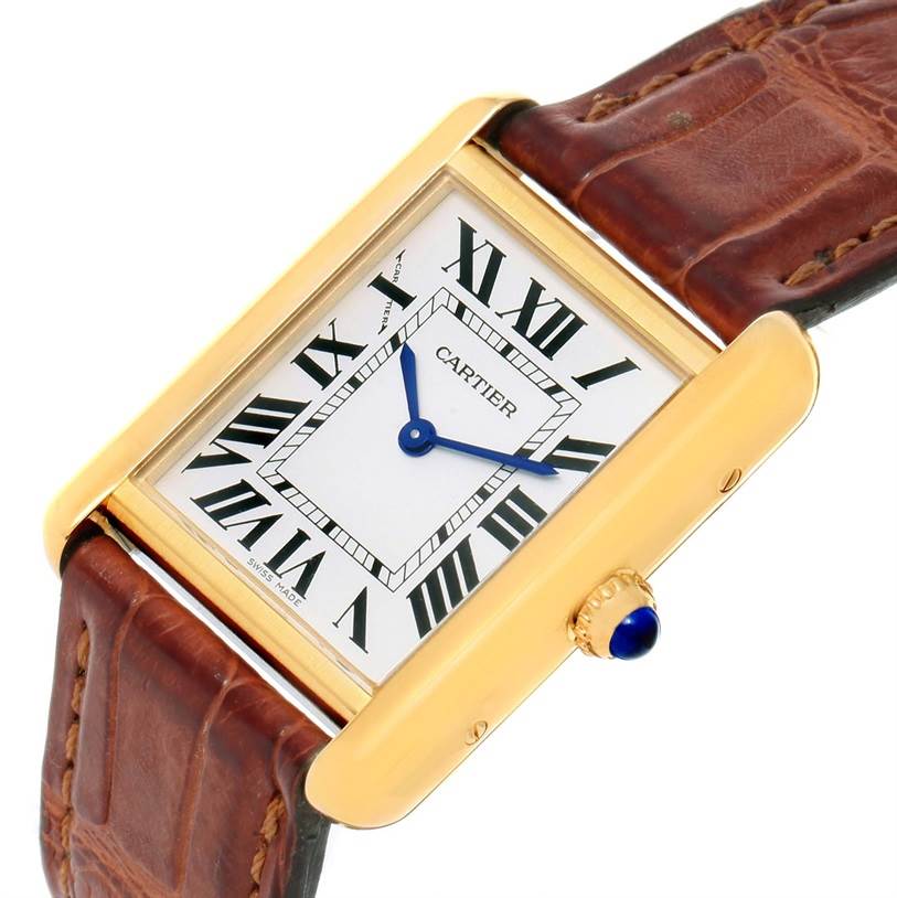 This image shows a Cartier Tank Solo W1018755 Women's Steel and Gold (two tone) Silver Dial W1018755 Women's Steel and Gold (two tone) Silver Dial watch at a tilted angle, highlighting the face, brown leather strap, and crown.