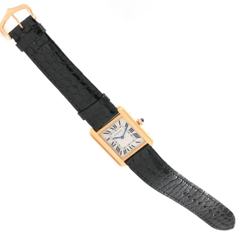 The image shows a top-down view of a Cartier Tank Solo W1018755 Women's Steel and Gold (two tone) Silver Dial W1018755 Women's Steel and Gold (two tone) Silver Dial watch with a black leather strap and a gold case.