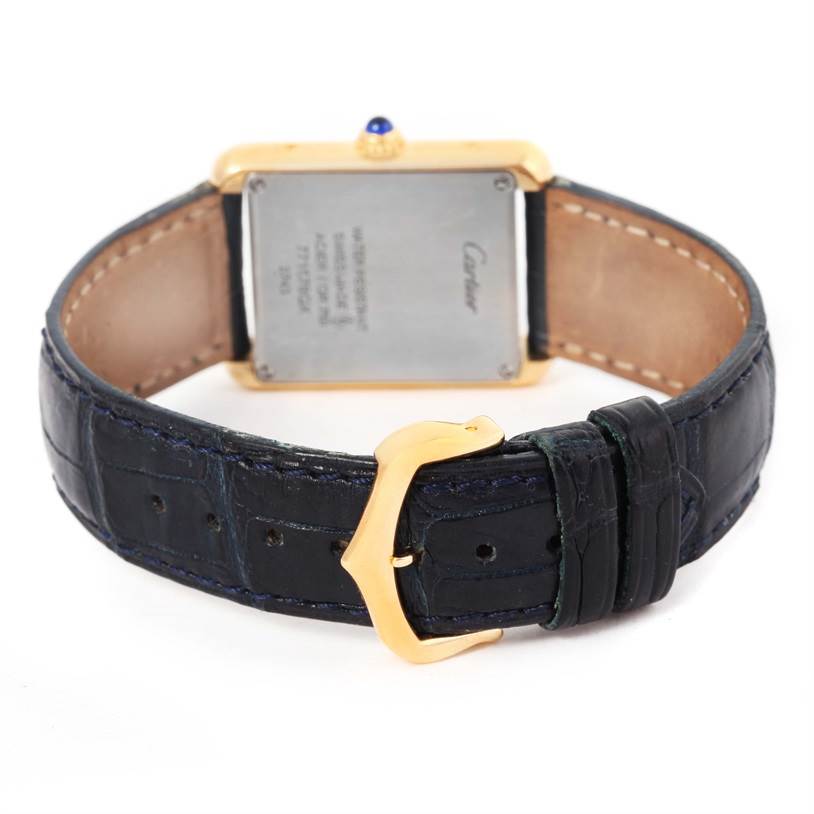 The image shows the back of the Cartier Tank Solo W1018755 Women's Steel and Gold (two tone) Silver Dial W1018755 Women's Steel and Gold (two tone) Silver Dial watch, focusing on the case back and buckle of the leather strap.