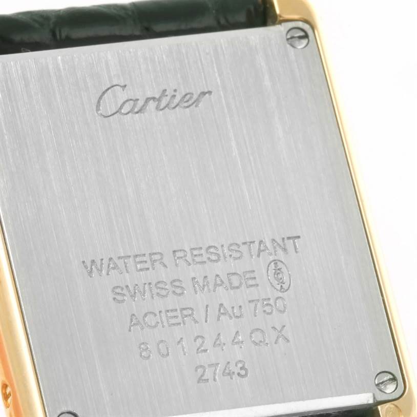 The image shows the back case of a Cartier Tank Solo W1018755 Women's Steel and Gold (two tone) Silver Dial W1018755 Women's Steel and Gold (two tone) Silver Dial watch, displaying engraved details and metal screws.