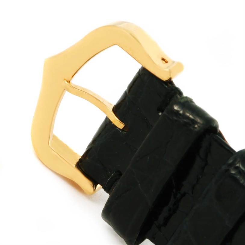 This image shows a close-up of the gold buckle and part of the black leather strap of the Cartier Tank Solo W1018755 Women's Steel and Gold (two tone) Silver Dial W1018755 Women's Steel and Gold (two tone) Silver Dial watch.