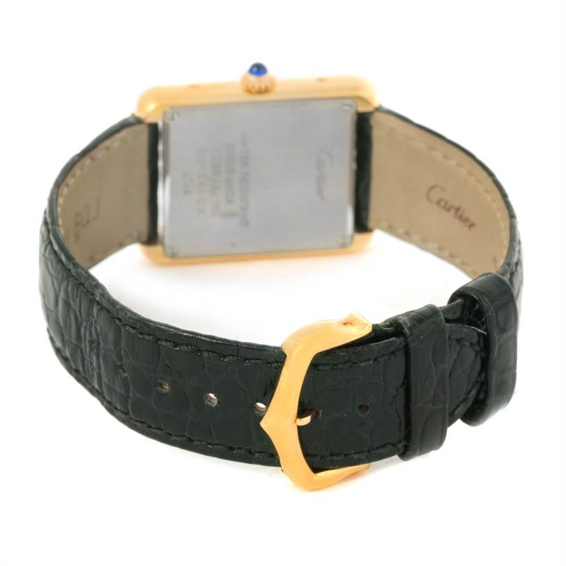 The image shows the back and strap of a Cartier Tank Solo W1018755 Women's Steel and Gold (two tone) Silver Dial W1018755 Women's Steel and Gold (two tone) Silver Dial watch, featuring a leather band and a gold buckle.