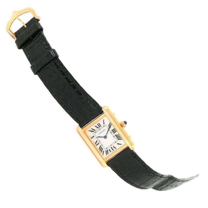The image shows a Cartier Tank Solo W1018755 Women's Steel and Gold (two tone) Silver Dial W1018755 Women's Steel and Gold (two tone) Silver Dial watch laid flat, displaying its face, black leather strap, and gold clasp at an angle.