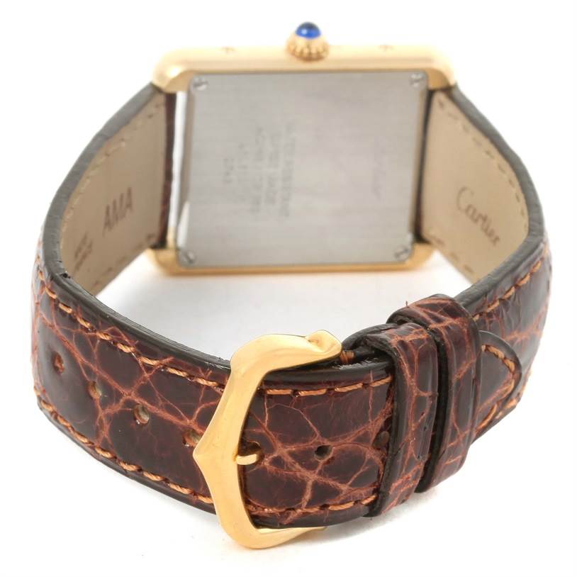 The image shows the backside and strap of a Cartier Tank Solo W1018755 Women's Steel and Gold (two tone) Silver Dial W1018755 Women's Steel and Gold (two tone) Silver Dial watch, featuring a gold buckle and brown leather strap.