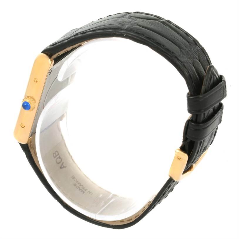 The image shows a side view of the Cartier Tank Solo W1018755 Women's Steel and Gold (two tone) Silver Dial W1018755 Women's Steel and Gold (two tone) Silver Dial watch, highlighting the gold casing, blue crown, and black leather strap.