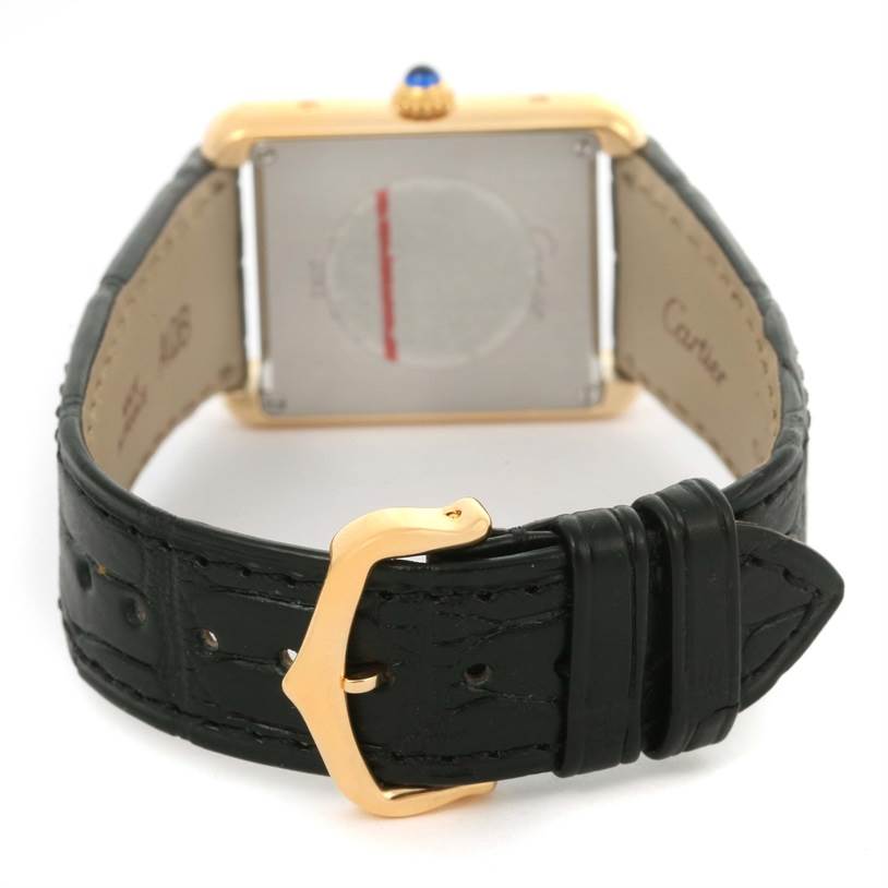 The image shows the back of the Cartier Tank Solo W1018755 Women's Steel and Gold (two tone) Silver Dial W1018755 Women's Steel and Gold (two tone) Silver Dial watch, focusing on the case back and leather strap with a gold buckle.