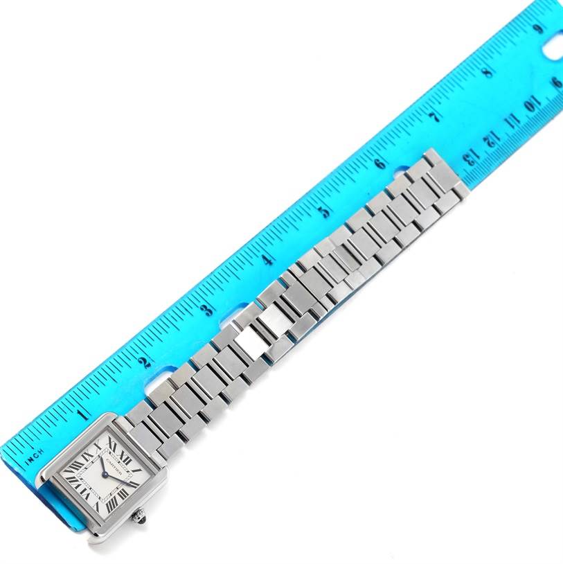 This image shows a full view of the Cartier Tank Solo W5200013 Women's Stainless Steel Silver Dial W5200013 Women's Stainless Steel Silver Dial watch, including its case, dial, and metal bracelet, alongside a ruler.