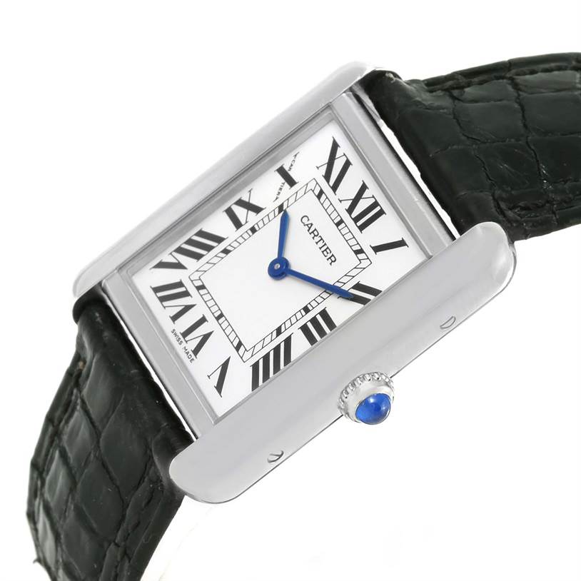 The Cartier Tank Solo W1018255 Women
s Stainless Steel Silver Dial W1018255 Women
s Stainless Steel Silver Dial watch is shown at a slight angle, highlighting the rectangular face, Roman numerals, and crown with a blue cabochon.