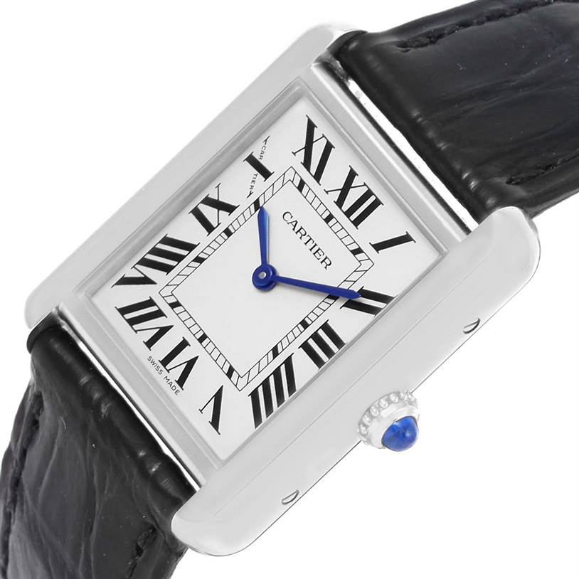 The image shows the Cartier Tank Solo W1018255 Women
s Stainless Steel Silver Dial W1018255 Women
s Stainless Steel Silver Dial watch at a tilted angle, highlighting its rectangular face, Roman numerals, and crown.