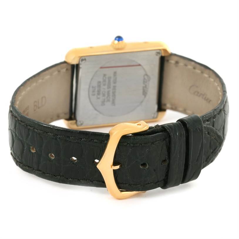 The image shows the back side of a Cartier Tank Solo W1018755 Women's Steel and Gold (two tone) Silver Dial W1018755 Women's Steel and Gold (two tone) Silver Dial watch, featuring its black leather strap and gold buckle.