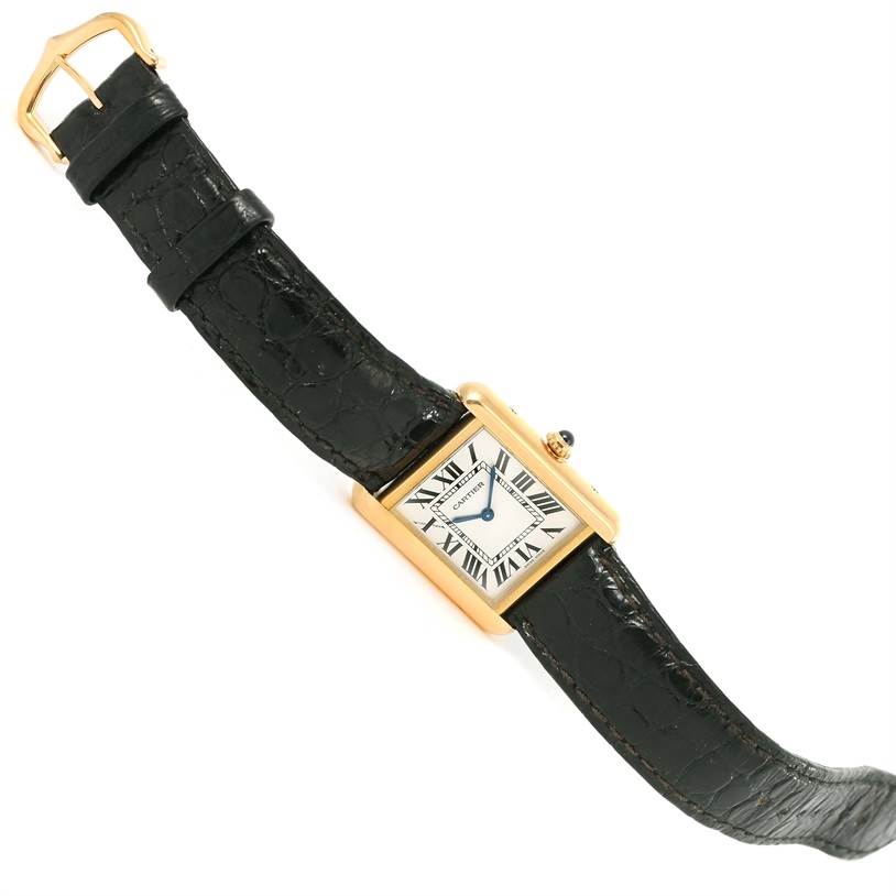 The watch is a Cartier Tank Solo W1018755 Women's Steel and Gold (two tone) Silver Dial W1018755 Women's Steel and Gold (two tone) Silver Dial model shown at an angle revealing the face, strap, and buckle.