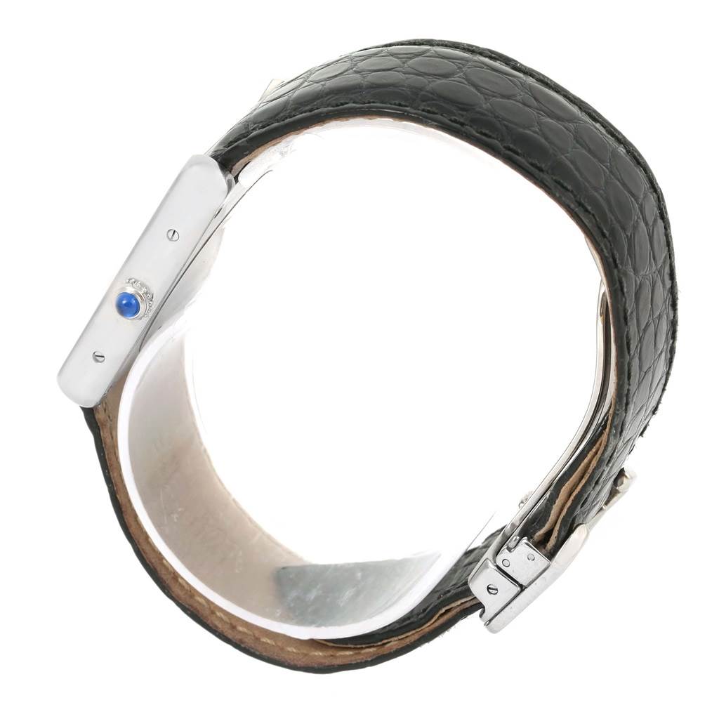 The image shows the Cartier Tank Solo W1018355 Men
s Stainless Steel Silver Dial W1018355 Men
s Stainless Steel Silver Dial watch from a side angle, highlighting its crown and leather band.