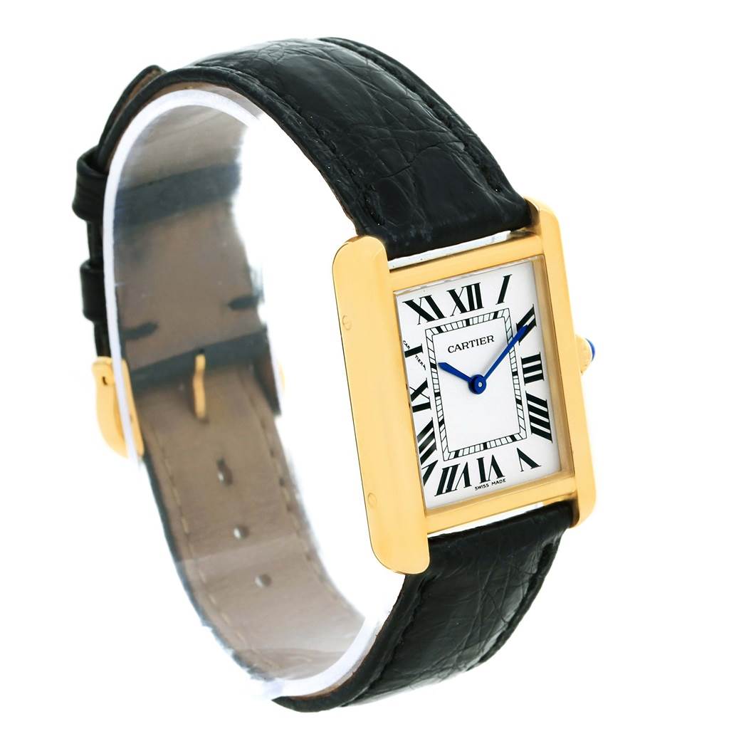 The image shows a Cartier Tank Solo W1018755 Women's Steel and Gold (two tone) Silver Dial W1018755 Women's Steel and Gold (two tone) Silver Dial watch with a rectangular gold case, Roman numeral dial, blue hands, and black leather strap.