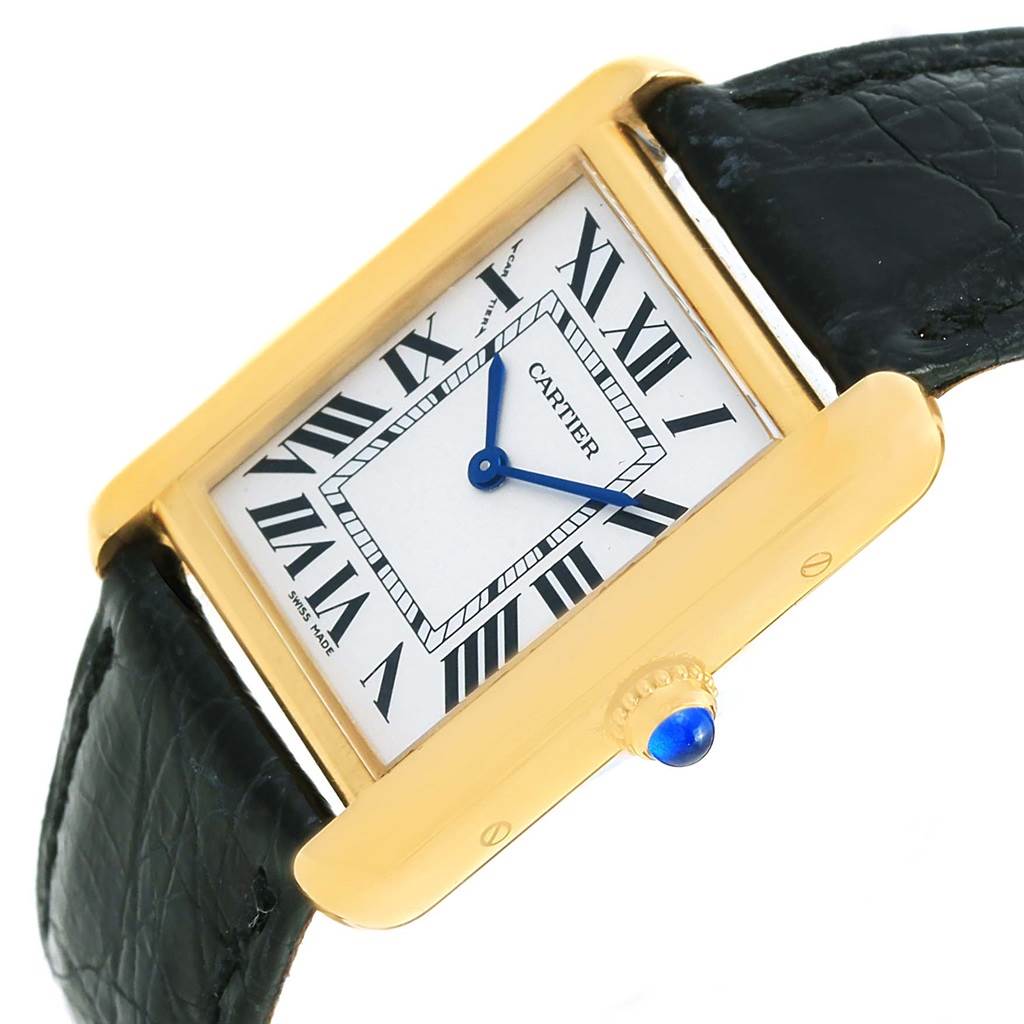 The image shows a Cartier Tank Solo W1018755 Women's Steel and Gold (two tone) Silver Dial W1018755 Women's Steel and Gold (two tone) Silver Dial watch at an angled view, highlighting its rectangular gold case, roman numeral dial, and black strap.