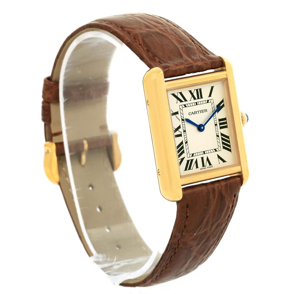 The Cartier Tank Solo W1018755 Women's Steel and Gold (two tone) Silver Dial W1018755 Women's Steel and Gold (two tone) Silver Dial watch is shown at an angled side view, displaying the square face, brown leather strap, and gold-tone case.