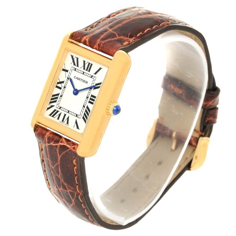 The Cartier Tank Solo W1018755 Women's Steel and Gold (two tone) Silver Dial W1018755 Women's Steel and Gold (two tone) Silver Dial watch is shown at a slight angle displaying its face, brown leather strap, and gold case with a blue crown.