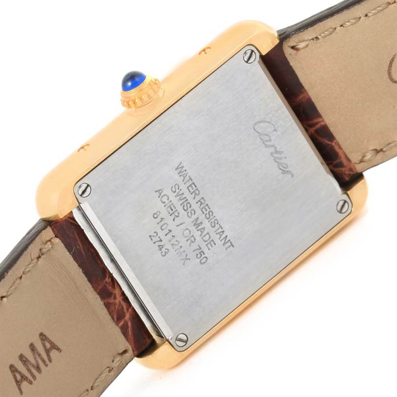 This image shows the back case and part of the leather strap of a Cartier Tank Solo W1018755 Women's Steel and Gold (two tone) Silver Dial W1018755 Women's Steel and Gold (two tone) Silver Dial watch.