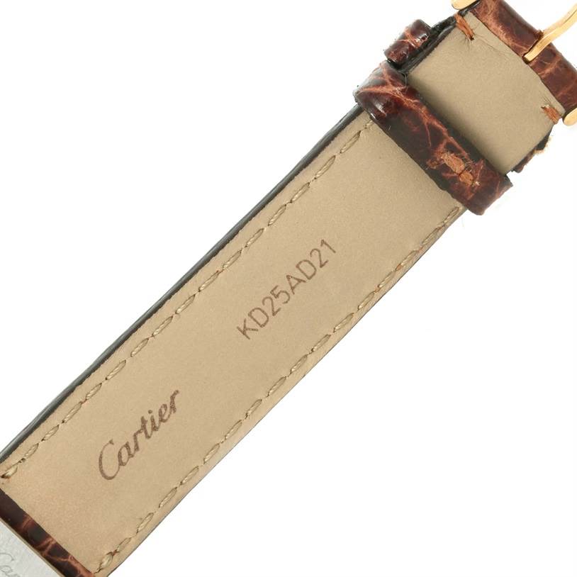 This image shows the back of the strap of a Cartier Tank Solo W1018755 Women's Steel and Gold (two tone) Silver Dial W1018755 Women's Steel and Gold (two tone) Silver Dial watch, featuring the Cartier logo and a serial number.