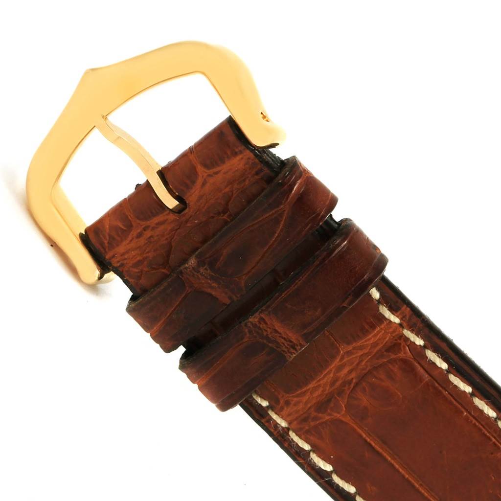 This image shows the gold buckle and part of the brown leather strap of the Cartier Tank Solo W1018755 Women's Steel and Gold (two tone) Silver Dial W1018755 Women's Steel and Gold (two tone) Silver Dial watch.