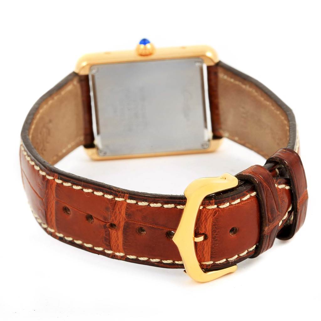 This image shows the back and strap of a Cartier Tank Solo W1018755 Women's Steel and Gold (two tone) Silver Dial W1018755 Women's Steel and Gold (two tone) Silver Dial watch, featuring a brown leather strap and gold buckle.