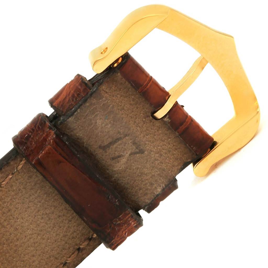 This image shows a close-up of the buckle and part of the leather strap of a Tank Solo model by Cartier.