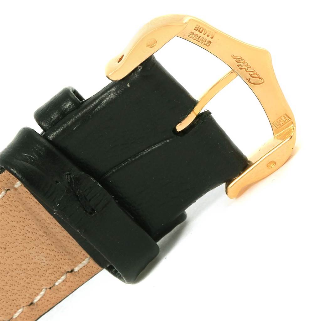 The image shows a close-up of the gold buckle and black leather strap of a Tank Solo model watch by Cartier.
