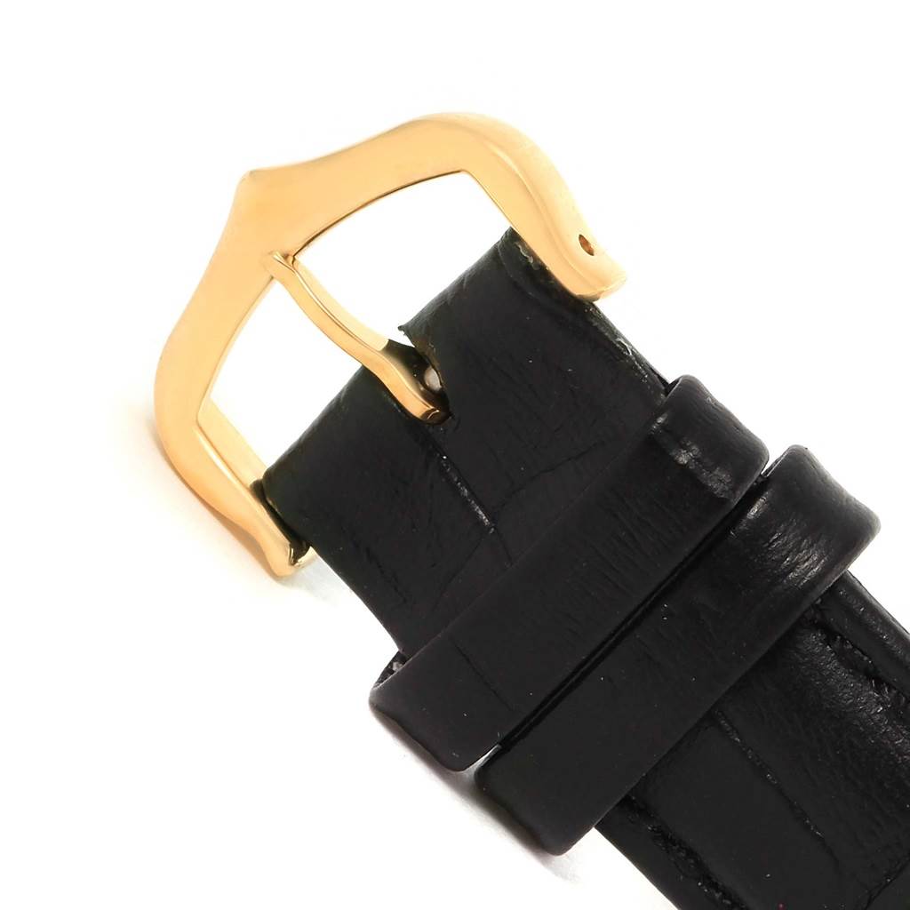 This image shows a close-up of the black leather strap and gold buckle from the Cartier Tank Solo W1018755 Women's Steel and Gold (two tone) Silver Dial W1018755 Women's Steel and Gold (two tone) Silver Dial watch.