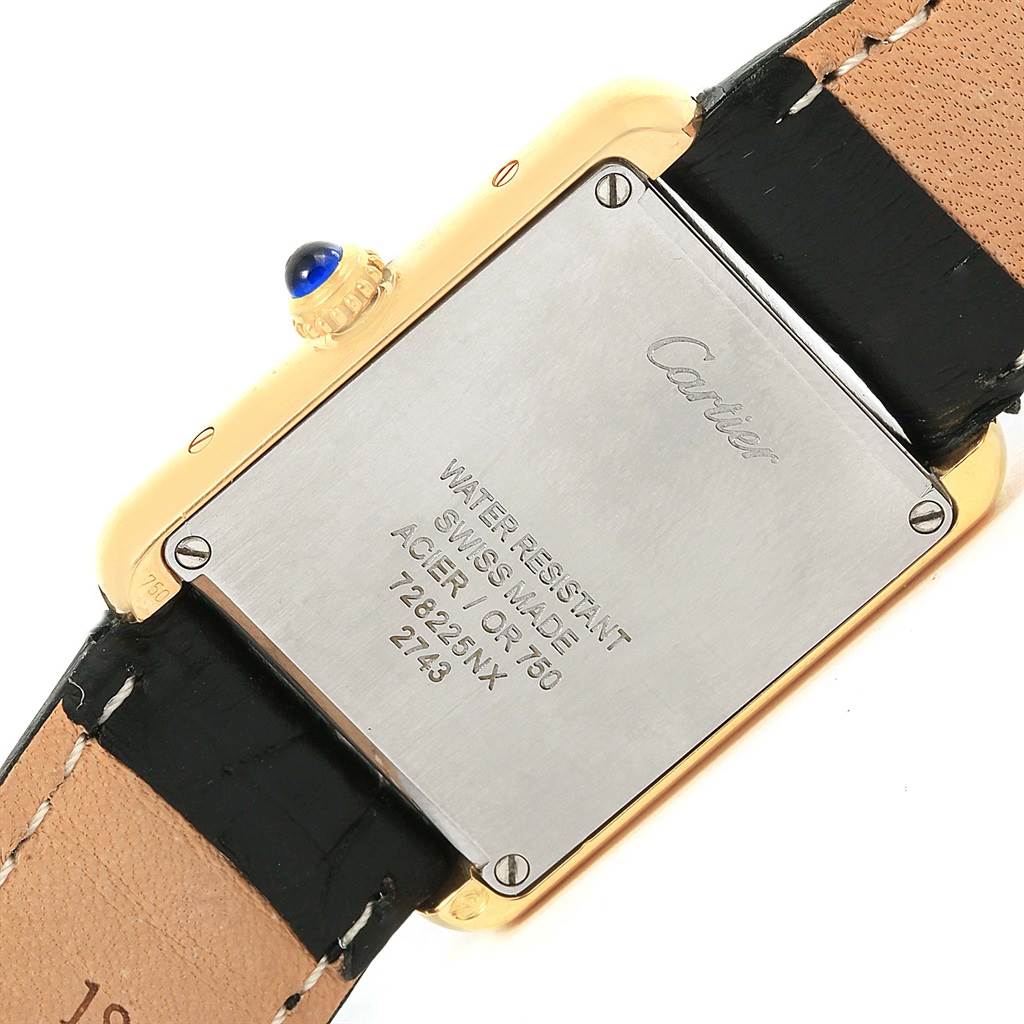 The image shows the back of a Cartier Tank Solo W1018755 Women's Steel and Gold (two tone) Silver Dial W1018755 Women's Steel and Gold (two tone) Silver Dial watch, displaying its casing, screws, and a leather strap.