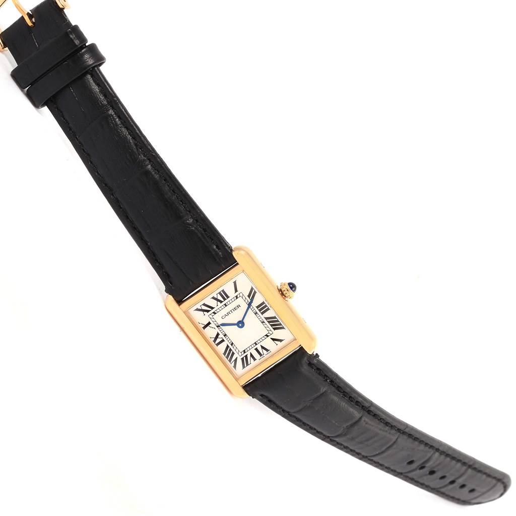 The image shows a Cartier Tank Solo W1018755 Women's Steel and Gold (two tone) Silver Dial W1018755 Women's Steel and Gold (two tone) Silver Dial watch from an angled top view, highlighting its black leather strap and gold rectangular case with a white dial.