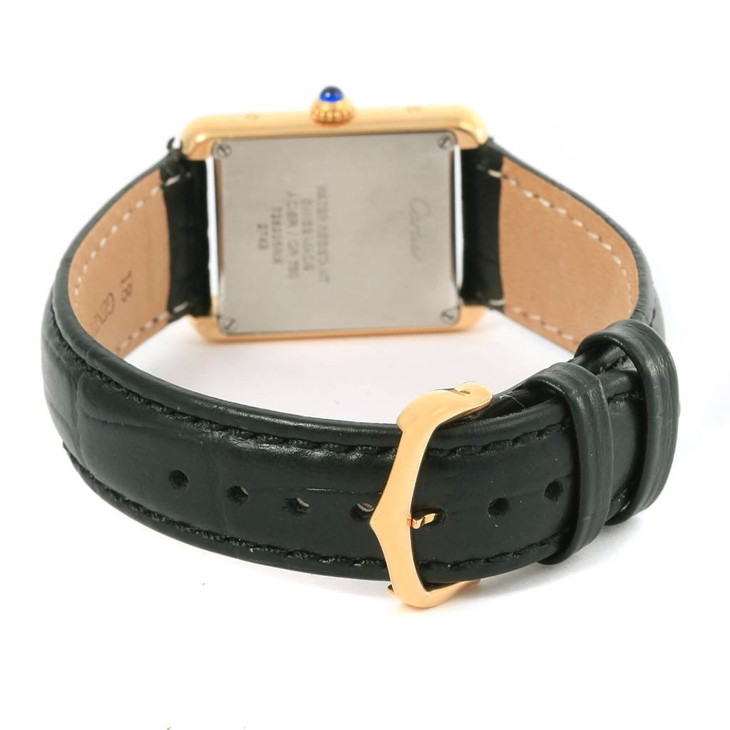 The Cartier Tank Solo W1018755 Women's Steel and Gold (two tone) Silver Dial W1018755 Women's Steel and Gold (two tone) Silver Dial watch is shown from the back, displaying its case back, crown, and black leather strap with a gold buckle.