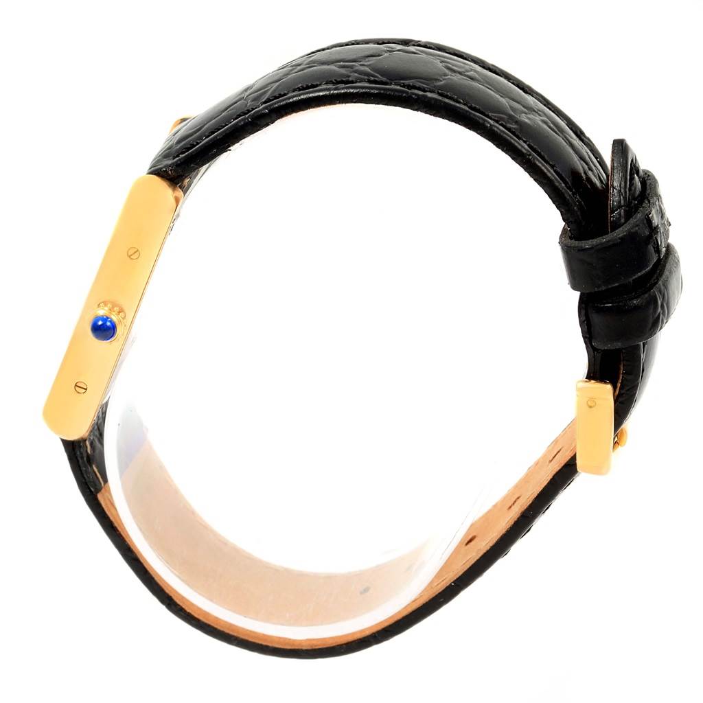 This image shows a side view of the Cartier Tank Solo W1018755 Women's Steel and Gold (two tone) Silver Dial W1018755 Women's Steel and Gold (two tone) Silver Dial watch, highlighting the crown and black leather strap.