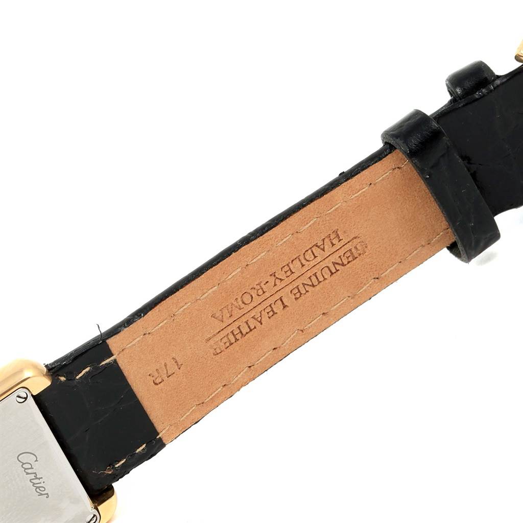 This image shows a close-up of the back of the strap of a Cartier Tank Solo W1018755 Women's Steel and Gold (two tone) Silver Dial W1018755 Women's Steel and Gold (two tone) Silver Dial watch, featuring 'GENUINE LEATHER' and 'HANDMADE IN ROMA' markings.