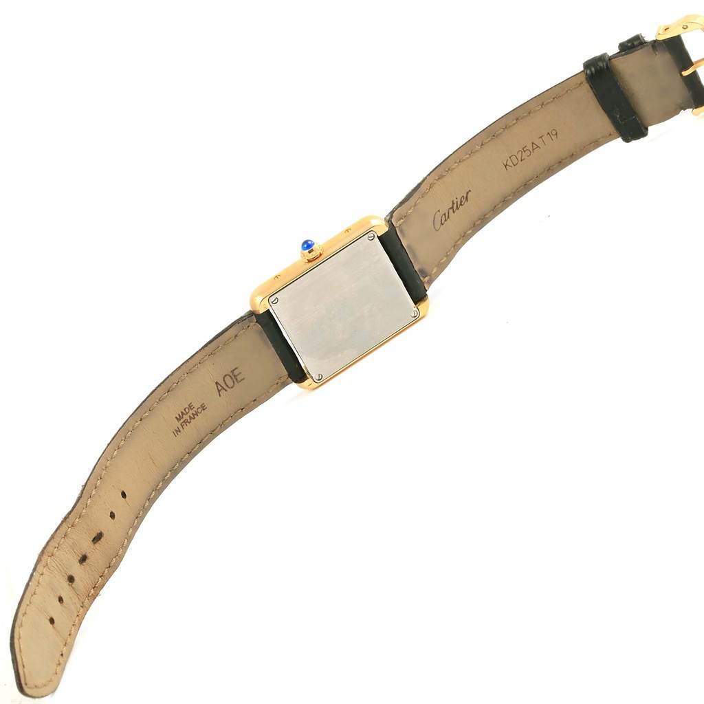 This image shows the back view of a Cartier Tank Solo W1018755 Women's Steel and Gold (two tone) Silver Dial W1018755 Women's Steel and Gold (two tone) Silver Dial watch, including its leather strap and case back.