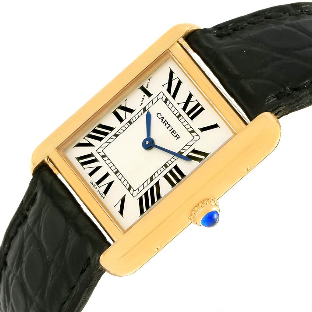 This image shows a Cartier Tank Solo W1018755 Women's Steel and Gold (two tone) Silver Dial W1018755 Women's Steel and Gold (two tone) Silver Dial watch at an oblique angle, highlighting its face, gold casing, and black leather strap.