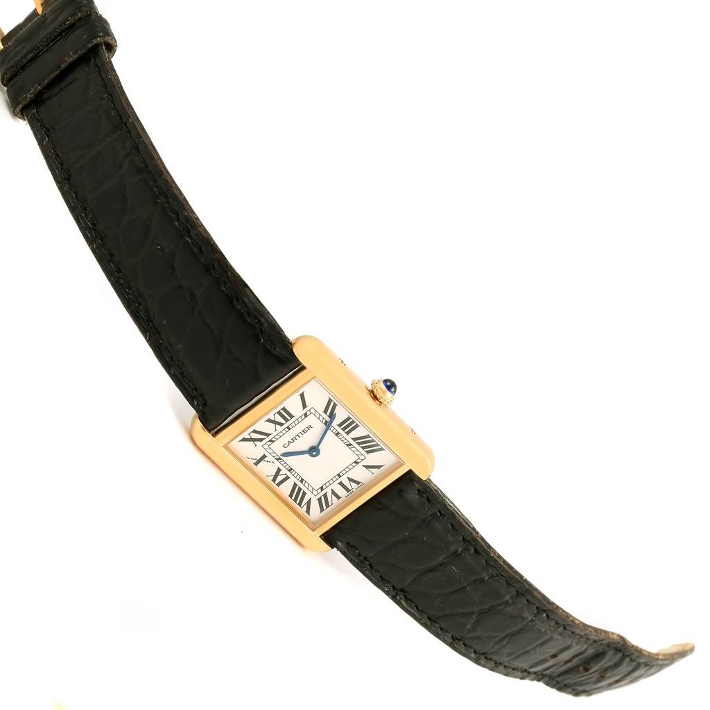 The image shows a top view of a Cartier Tank Solo W1018755 Women's Steel and Gold (two tone) Silver Dial W1018755 Women's Steel and Gold (two tone) Silver Dial watch, featuring its rectangular face and black leather strap.