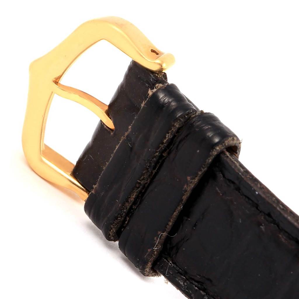 This image shows a close-up of the gold buckle and black leather strap of a Cartier Tank Solo W1018755 Women's Steel and Gold (two tone) Silver Dial W1018755 Women's Steel and Gold (two tone) Silver Dial watch.