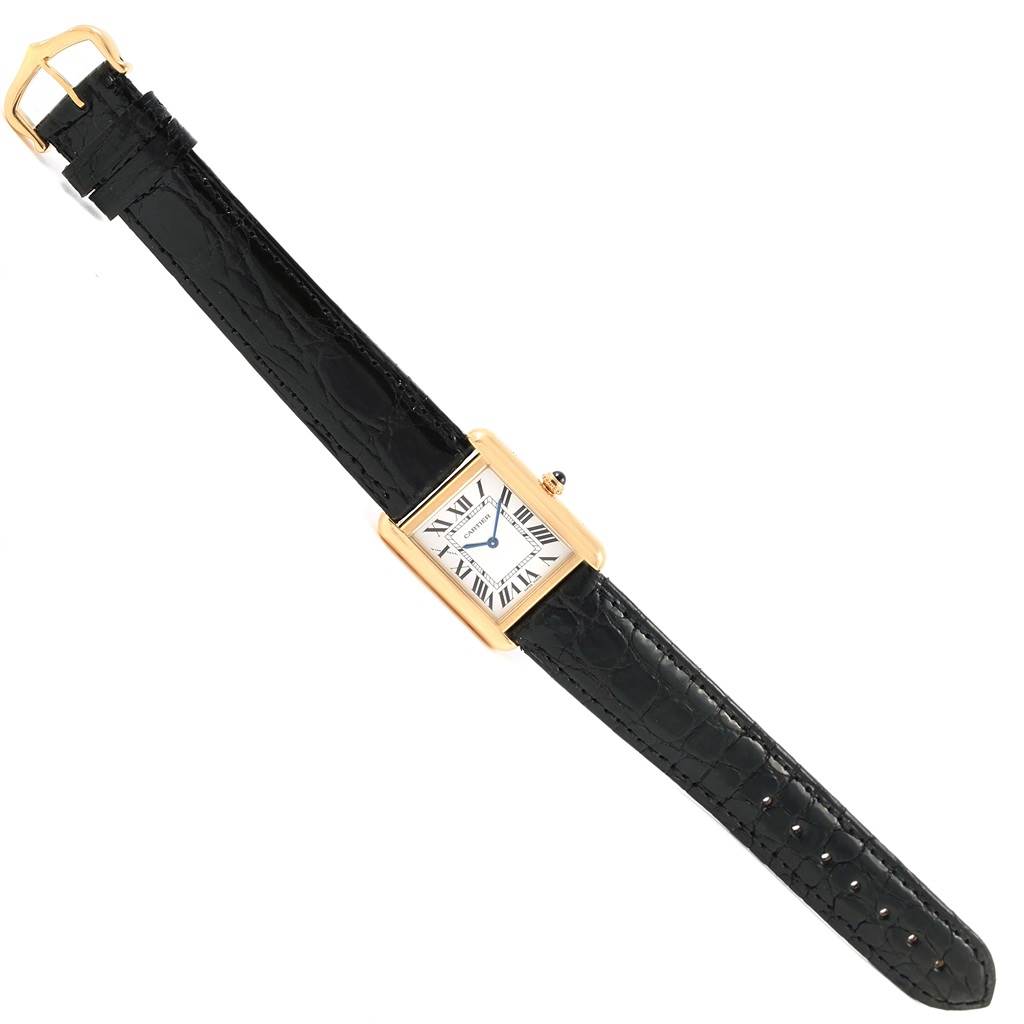 This Tank Solo Cartier watch is shown flat, showcasing the black leather strap and rectangular gold case.